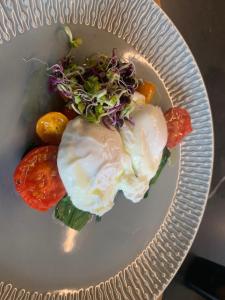 a plate of food with eggs and vegetables on it at Franklin38 in Auckland