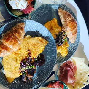 three plates of breakfast foods on a table at Franklin38 in Auckland