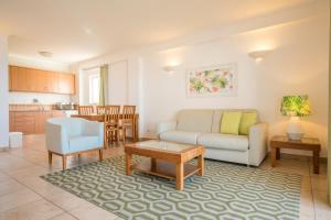 a living room with a couch and a table at Clube Porto Mos - Sunplace Hotels & Beach Resort in Lagos