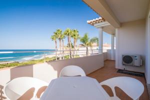 a balcony with a view of the beach at Clube Porto Mos - Sunplace Hotels & Beach Resort in Lagos