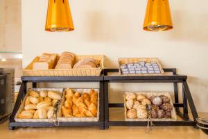 a shelf filled with lots of different types of bread at Clube Porto Mos - Sunplace Hotels & Beach Resort in Lagos