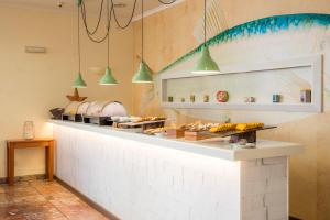 a kitchen with a counter with food on it at Clube Porto Mos - Sunplace Hotels & Beach Resort in Lagos