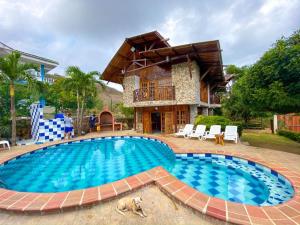 a large swimming pool in front of a house at Cabana Dubai Resorts in Santa Verónica