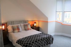 a bedroom with a bed and a window at Valentine City Centre Guest House in Edinburgh