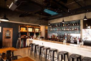a bar with a row of stools in a restaurant at MARINX CLASSIC HARBORVIEW PENSION in Yaese