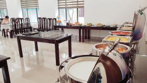 a restaurant with a buffet of food on display at MOMALI Hotel Ninh Binh in Ninh Binh