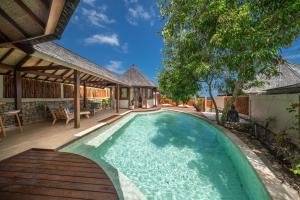 a swimming pool in the backyard of a house at Blue Lagoon Avia Villas in Nusa Lembongan