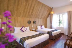 Postel nebo postele na pokoji v ubytování TTC Dreamy Hill Resort - Unlimited Access to TTC World - Thung Lung Tinh Yeu