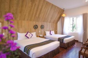 Giường trong phòng chung tại TTC Dreamy Hill Resort - Unlimited Access to TTC World - Thung Lung Tinh Yeu