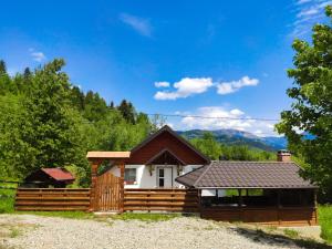 una casa con una recinzione in legno e una casa di Casa Didea a Borşa