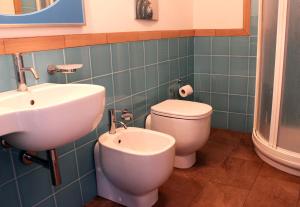 a bathroom with a sink and a toilet at Hotel O'scià in Lampedusa