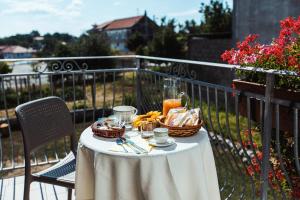 a table with baskets of food and drinks on a balcony at Al Chiaro di Luna in Agerola