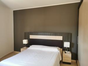 A bed or beds in a room at La Maison Latina Guest House