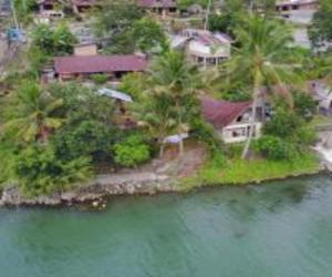 an aerial view of a house on an island in the water at Laster Jony's in Tuk Tuk