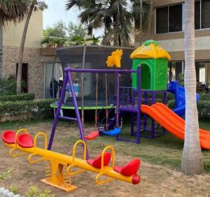a playground filled with lots of green and yellow umbrellas at Tahir Guest Palace in Kano