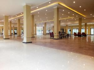an empty lobby with chairs and tables in a building at Pendopo 45 Resort in Bogor