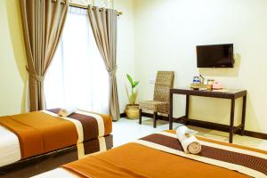 Postel nebo postele na pokoji v ubytování Pendopo 45 Resort