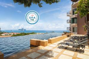 a resort swimming pool with a view of the ocean at Avani Ao Nang Cliff Krabi Resort in Ao Nang Beach