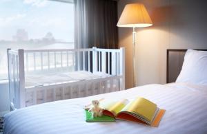 
a bed with a book and a pillow on top of it at Hotel New Otani Osaka in Osaka
