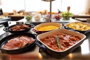 a group of bowls of food on a counter at Shizutetsu Hotel Prezio Tokyo Tamachi in Tokyo