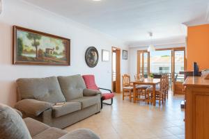 a living room with a couch and a table at Bellavista in Port d'Alcudia