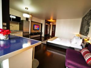 a living room with a couch and a kitchen at Sector 6 - Metrou Gorjului - Studio G by MRG Apartments in Bucharest