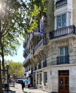 a building with a sign on the side of it at Hotel Studia in Paris