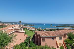 a view of a house with the ocean in the background at Baia de Bahas Residence in Golfo Aranci