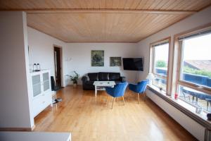 a living room with a couch and a table and chairs at Lovely house in Tórshavn in Tórshavn