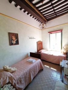 a bedroom with two beds and a window at La Calona in Camaiore