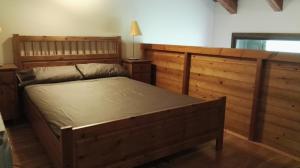 a bedroom with a large wooden bed and a desk at Dúplex Àreu, Pallars in Areu +18 photos