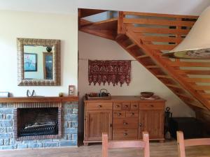 a living room with a fireplace and a wooden dresser at Dúplex Àreu, Pallars in Areu