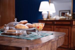 a table with a plate of pastries on a table at Mirò B&B in Acquaviva delle Fonti