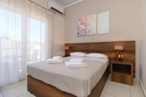 Postel nebo postele na pokoji v ubytování Olympic Hotel