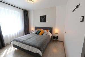a bedroom with a bed and a large window at Comfy 2 Room Apartment - Free Parking - 350Mbps WiFi - Netflix in Kaunas