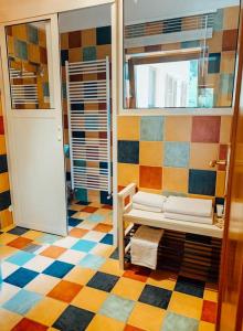 a colorful room with a bench and a window at Počitniška hiša Lazar in Kobarid