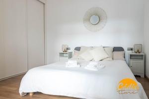 a white bedroom with a large white bed with a mirror at Corazon del Mar - FREE PARKING by Cadiz Time in Cádiz