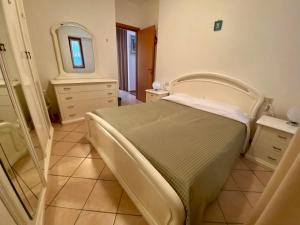 a bedroom with a hospital bed and a mirror at casa alla Valle in Salò