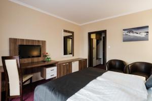 Posteľ alebo postele v izbe v ubytovaní Hotel Menhard