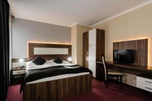 Posteľ alebo postele v izbe v ubytovaní Hotel Menhard