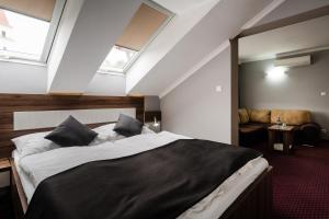 Posteľ alebo postele v izbe v ubytovaní Hotel Menhard