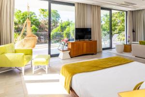 a hotel room with a large bed and a television at Fazenda Viegas in Lagos