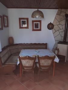 a dining room with a table and two chairs at House H-ELIOS in Lovran