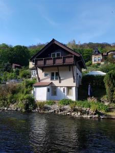 a house sitting on the side of a river at Ferienhaus Enno in Altenbrak
