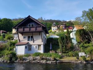 a house on a hill next to the water at Ferienhaus Enno in Altenbrak