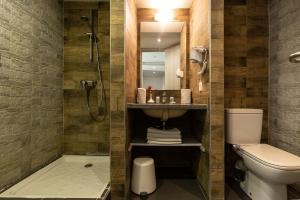 a bathroom with a shower and a toilet and a sink at Wazo Appart-Hôtel in Marrakesh