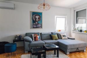 a living room with a couch and a table at Apartment Jupiter in Tuzla