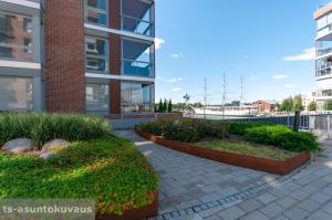 a building with two planters in front of a building at The Best View in Turku with private balcony, sauna, car park in Turku