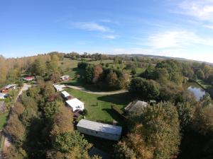 an aerial view of a farm with a group of trailers at Camping la Nouvelle Aventure in Audincthum