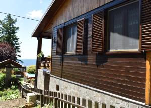 a house with a window on the side of it at Baita La Stradella in Serravalle